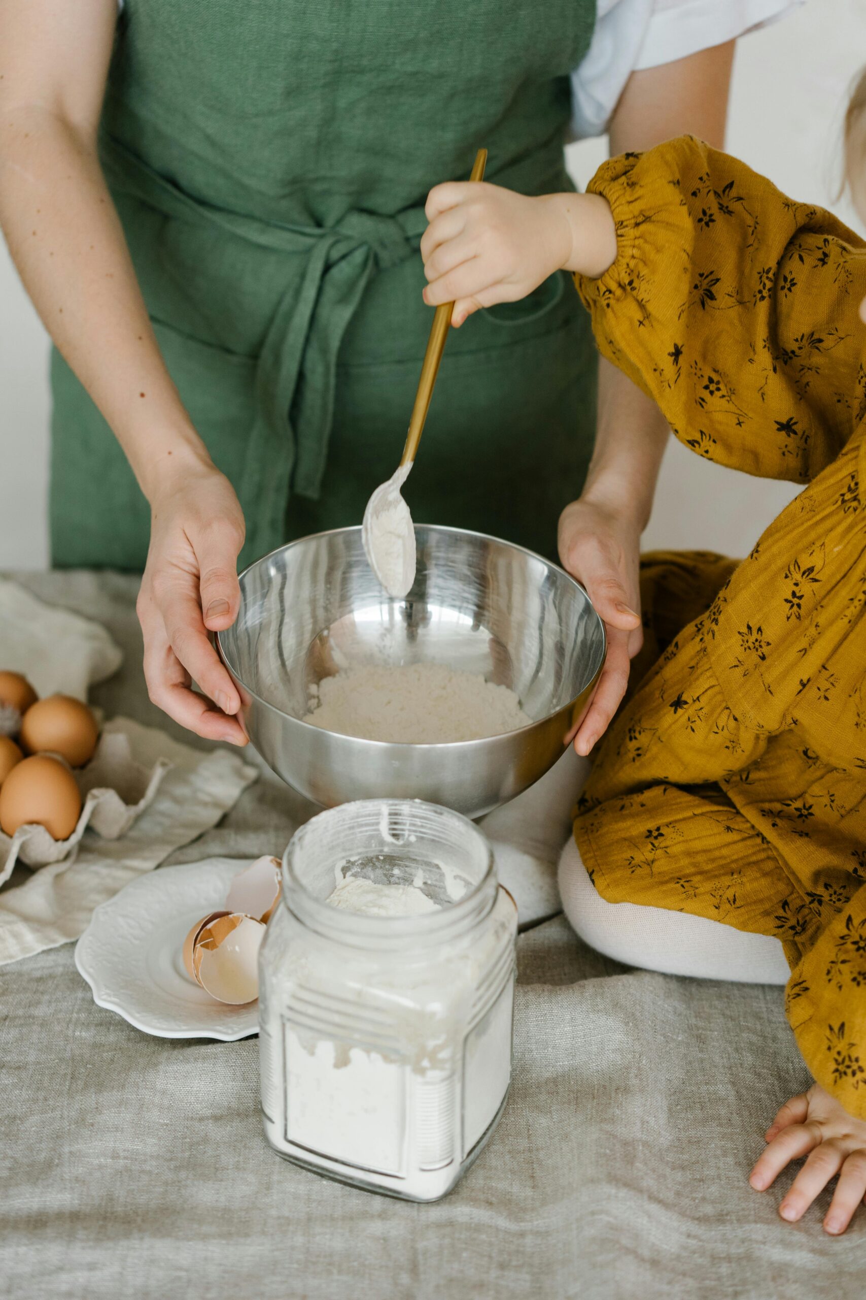 Home Mother and child mixing dough in a bowl, symbolizing family togetherness and home baking.